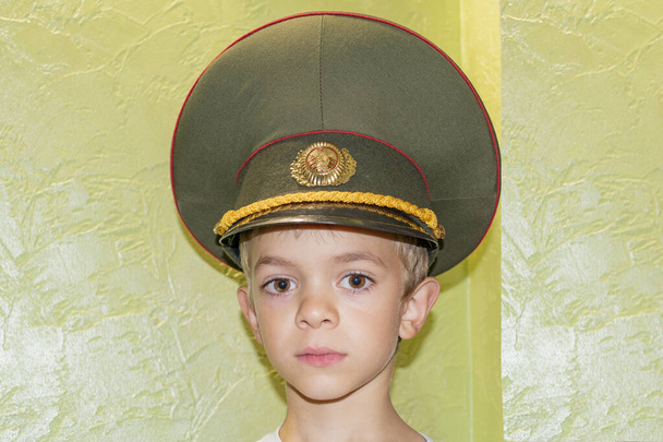 A little boy posing in an officer's cap - Photo, Image