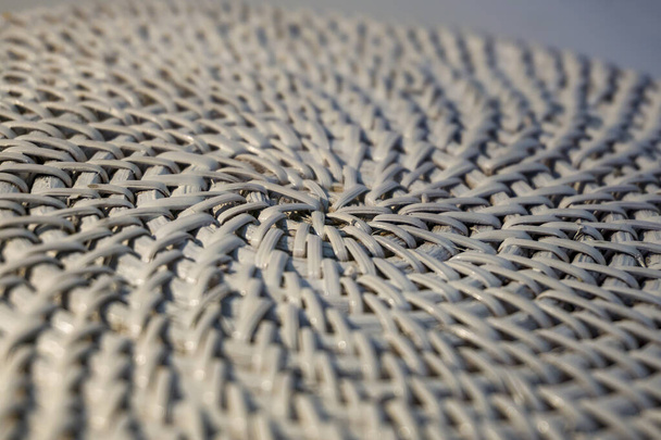 Close up diagonal texture of straw weave in circle pattern, around the center. Selective focus on central point. Ecological materials for design. - Photo, Image
