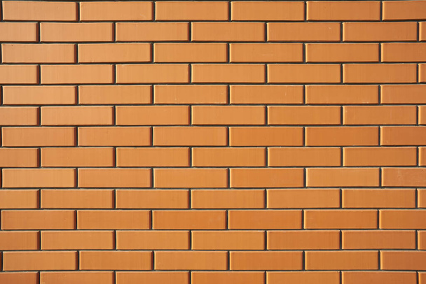 Red brick wall on a sunny day - Fotó, kép