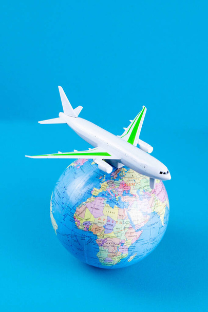 Plastic toy plane on the globe. Flight travel concept. Travel by airplane. Takeoff and landing of the aircraft. Return home from flight. empty Copy space. - Photo, Image