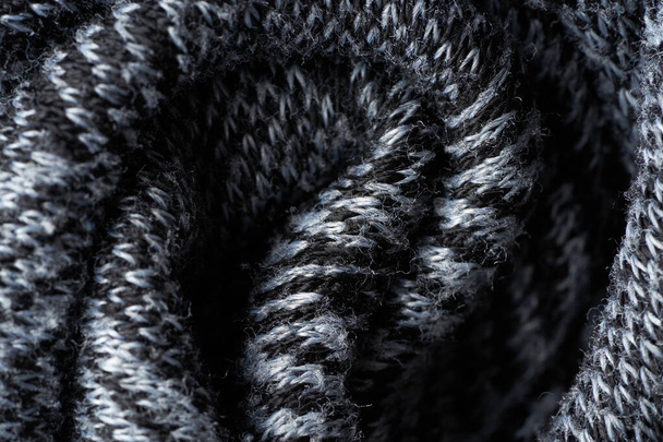 Closeup gray texture of woolen knitted fabric. Pattern of gray crumpled fabric. High-quality selective focus macro photography. - Φωτογραφία, εικόνα