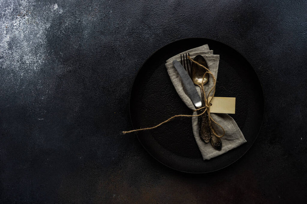 Table setting with cutlery and napkin on concrete background with copy space - Fotografie, Obrázek
