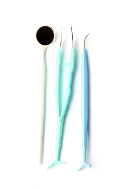 Dentist's medical equipment tools on white background - 写真・画像