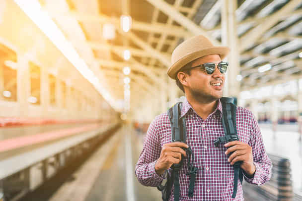 Young traveler man at platform train station. Traveling concept. - Valokuva, kuva