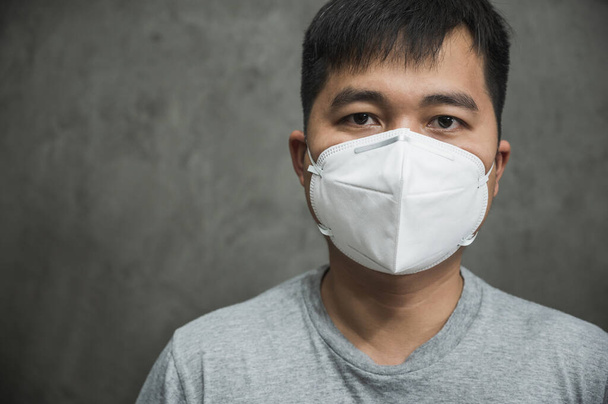 Close up young asian man wearing protection face n95 mask against coronavirus. - Φωτογραφία, εικόνα