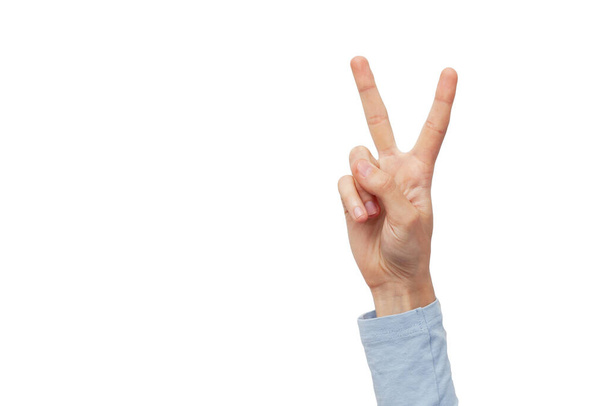 a hand on a white background shows a sign. Two fingers count signs on white background  - Foto, Bild