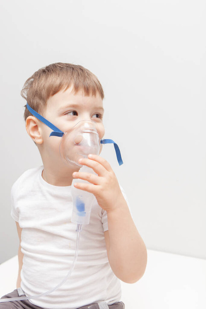 The boy makes inhalations. Treatment at home. Disease prevention - Photo, Image
