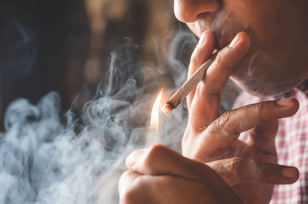 Close up young man smoking a cigarette. - Фото, зображення