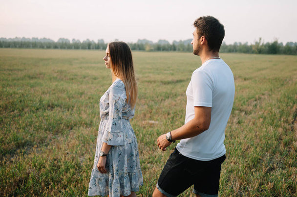A girl and a guy are walking in the park. Portrait of a couple, a love story.Happy smiling, loveling couple together outstretched at beautiful nature. Lovestoty - Foto, immagini