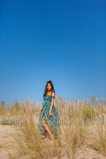 Free happy woman enjoying sun on vacations in dunes - Fotó, kép