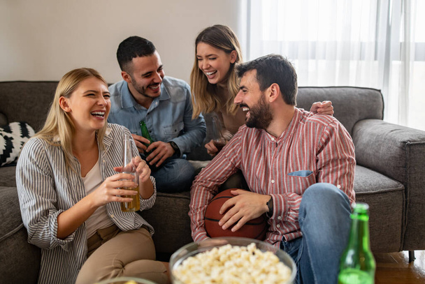 Group of friends preparing to watch football game at home.People,love,happiness and technology concept. - Photo, Image