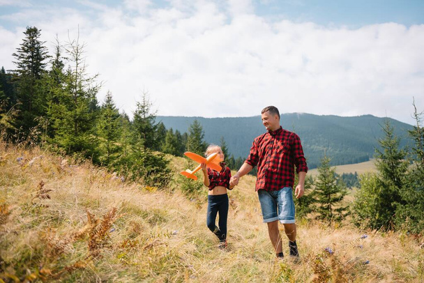 Happy father and little child are walking in the mountains. Father's Day. vacation in the national park - Фото, изображение
