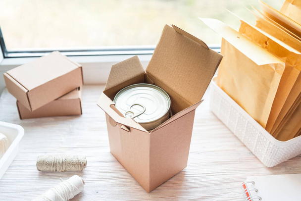 Food tin can packed in carton box, food delivery concept - Valokuva, kuva