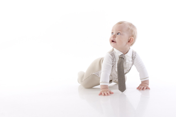 Smiling baby-boy in a romper suit crawling - Fotografie, Obrázek