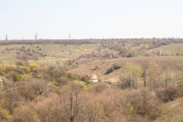 spring in the city of Dnieper in the afternoon in the sun one house in a meadow among - Foto, imagen