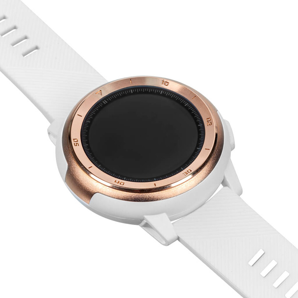 Wireless smart watch in a round matte gold case with numbers on the rim and a silicone strap on a white background. Diagonal view - Photo, Image