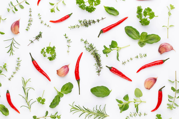 Spice herbal leaves and chili pepper on white background. Vegetables pattern. Floral and vegetables on white background. Top view, flat lay. - Foto, Imagen