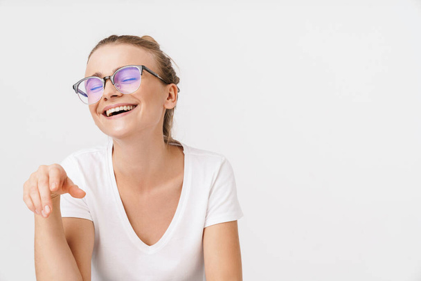 Photo of beautiful happy woman in eyeglasses laughing with eyes closed isolated over white background - Foto, afbeelding