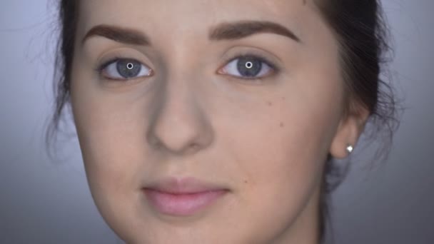 Natural Beauty. Beautiful woman with makeup looks at the camera - Video