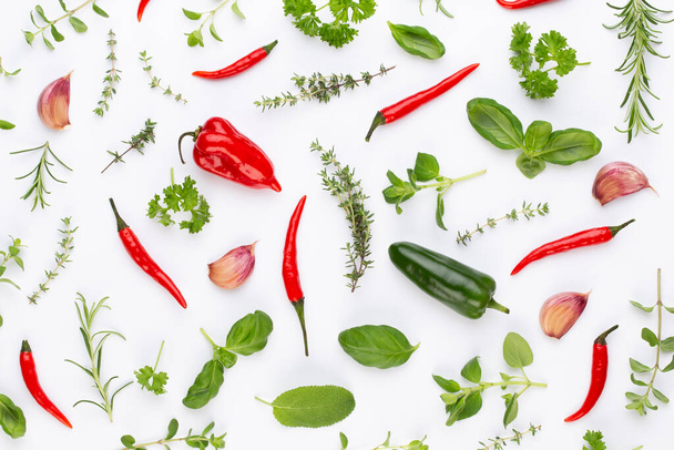 Spice herbal leaves and chili pepper on white background. Vegetables pattern. Floral and vegetables on white background. Top view, flat lay. - Fotografie, Obrázek