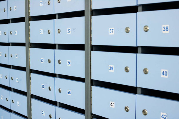 Blue wooden mailboxes in a row closeup - Zdjęcie, obraz