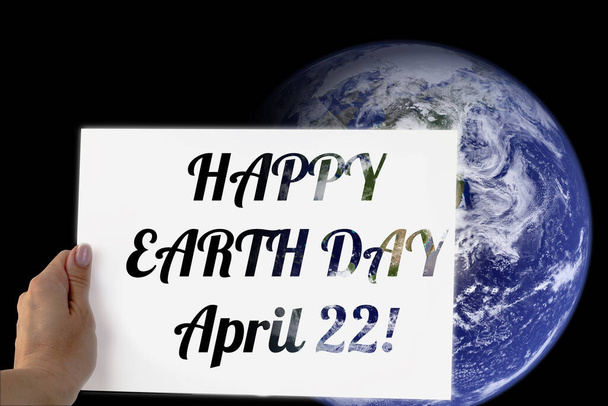Föld Napja plakát, április 22, a felirat a plakáton a bolygó hátterén, térrel. A kép elemeit a NASA bocsátotta rendelkezésre.. - Fotó, kép