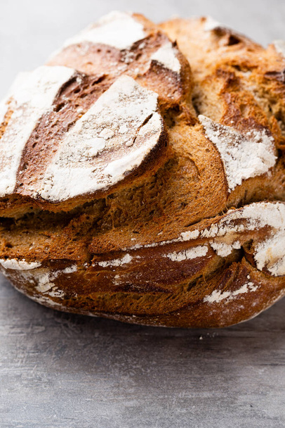 Freshly baked bread on dark gray kitchen table, top view. - Zdjęcie, obraz