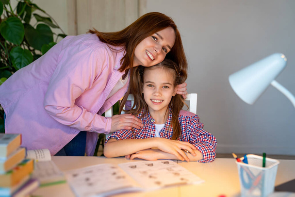 mom and daughter doing lessons, distance learning - 写真・画像