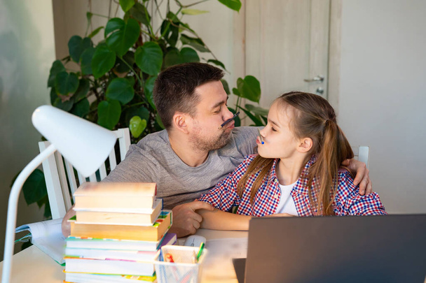 cheerful daddy helps daughter distance learning - Photo, image