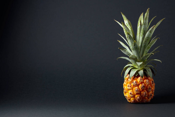 Ripe and juicy pineapple on a black background. Copy space. - Φωτογραφία, εικόνα