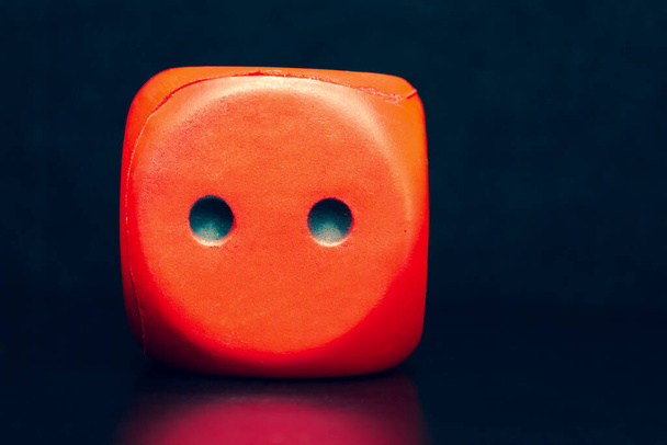 Big dice of red color on a black background - Photo, Image
