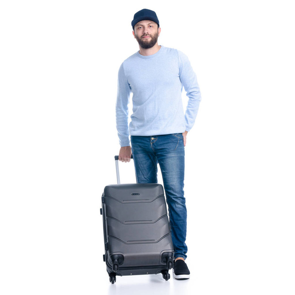 Man in jeans with travel suitcase standing - 写真・画像