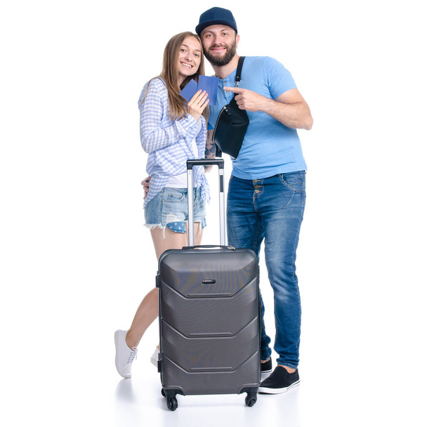 happy couple of tourists with black suitcase luggages smiling with passports - Valokuva, kuva