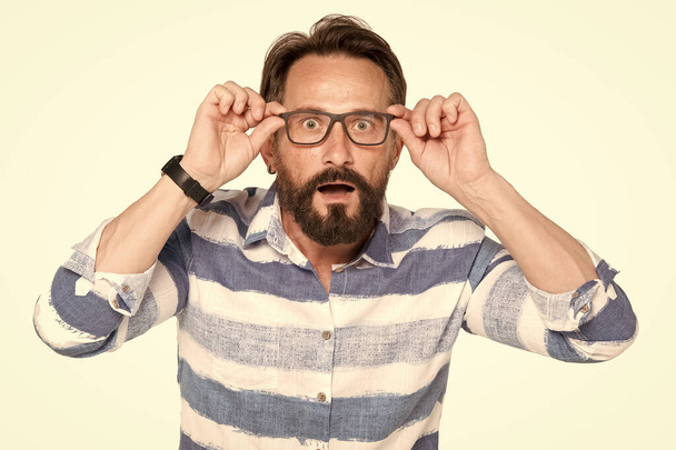 Man in glasses with shocked, amazed expression isolated on white background. Frustrated bearded young handsome man. Portrait of young surprised man with opened mouth on white. - Fotografie, Obrázek