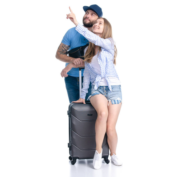 feliz pareja de turistas con maletas negras equipaje sonriendo mostrando señalando
 - Foto, Imagen