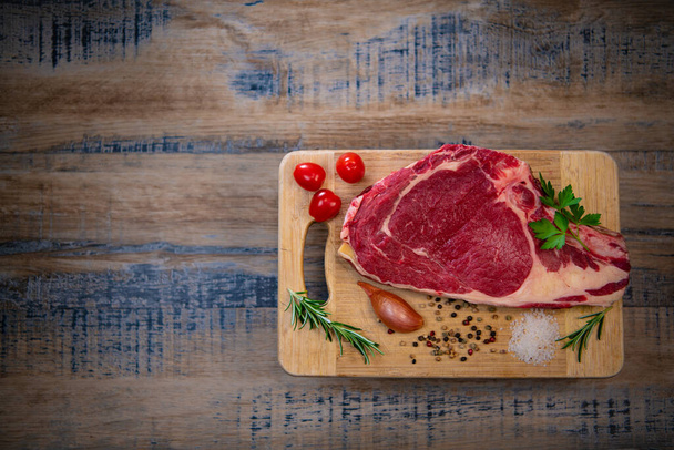 Raw T Bone steak on wooden board prepared to Grill  - Φωτογραφία, εικόνα