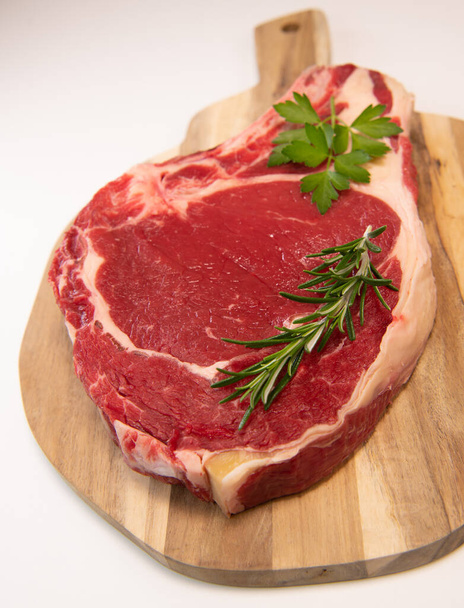 Raw T Bone steak on wooden board prepared to Grill  - Foto, imagen