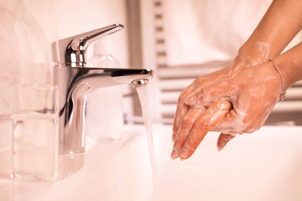 Washing of hands with soap under running water - Foto, afbeelding