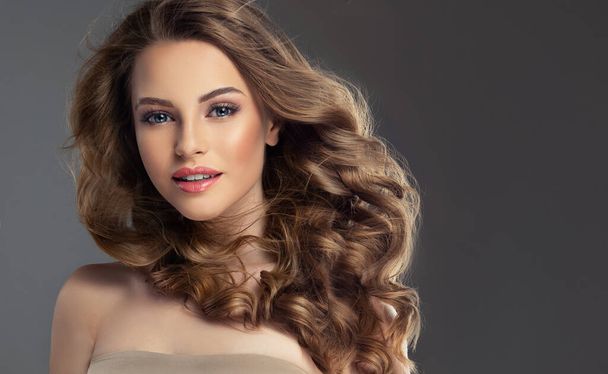 Young, brown haired woman with wavy hair .Beautiful model with long,  hairstyle. - Photo, Image