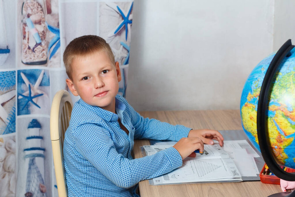 child sits at desk and does lessons.stay at home, distance learning - Фото, зображення