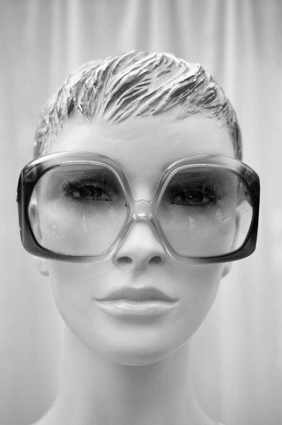 cool female face in the style of the 1970s with stylish sunglasses and hat - Photo, image
