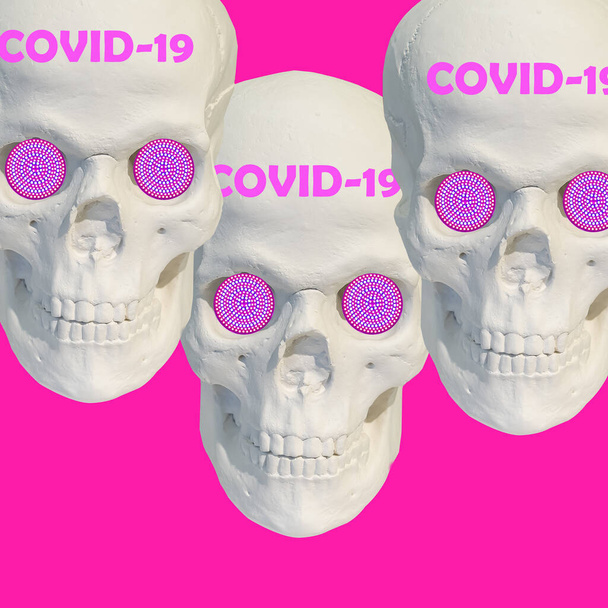 Collage moderner Kunst. Drei weiße Totenschädel-Skulpturen auf rosa Hintergrund mit Text covid-19. Coronavirus-Konzept. Coronavirus-Ausbruch. Weltweite Pandemie - Foto, Bild