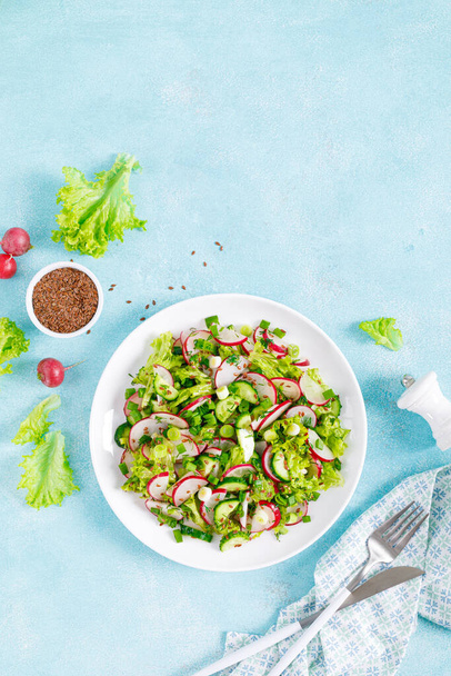 Fresh vegetable salad with radish, cucumbers, lettuce, dill and green onion - Фото, изображение