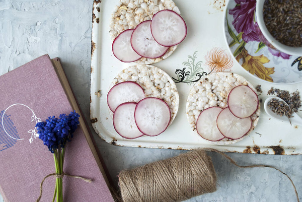reading snack, lavender tea and rice cookies with radish - Photo, Image