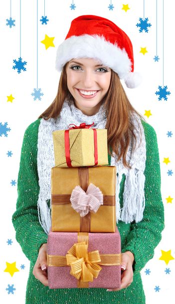 Beautiful smiling girl in New Year hat with gifts isolated on white - Foto, imagen