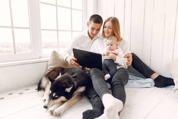 Beautiful family spend time in a bedroom with a tablet - Φωτογραφία, εικόνα