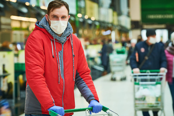 man with face mask at shopping center. coronavirus outbreak - 写真・画像