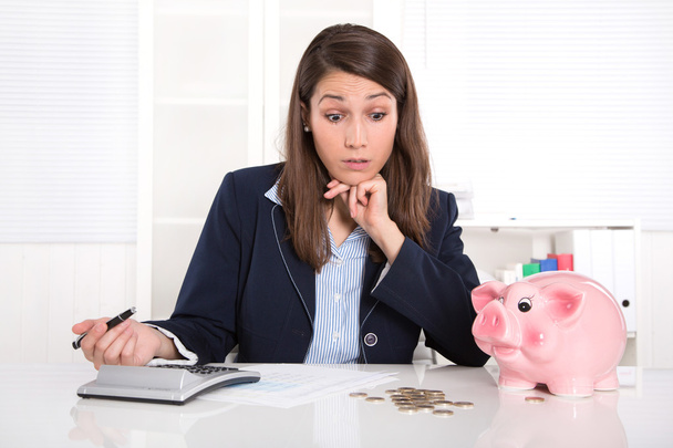Pretty caucasian businesswoman in depression with piggy bank. - Zdjęcie, obraz
