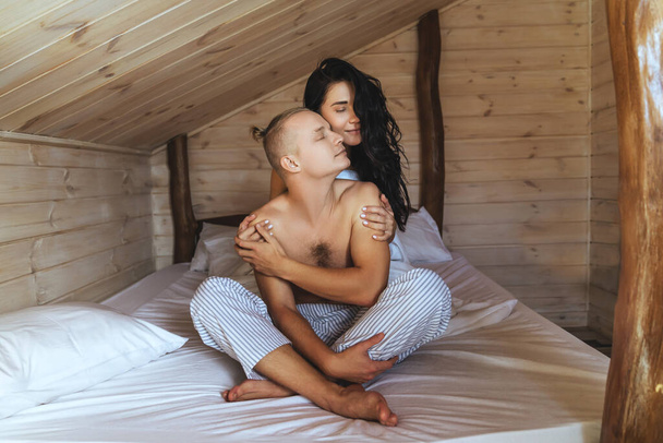 Image of cute young couple in love on bed. - Foto, afbeelding