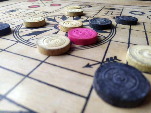 Carrom board or Karrom , carrom men, and queen. Close up - Photo, Image
